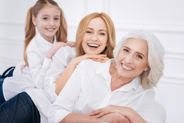 Cheerful family members sitting on the couch