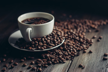cup with a drink and coffee beans