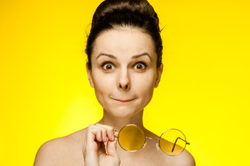 yellow glasses in hands, wide open eyes...