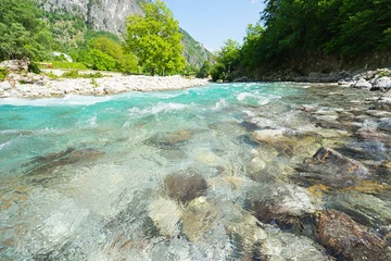 Zelfklevend Fotobehang Mountain river with clean blue water. Selective focus. © upslim
