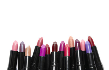 A variety of lipstick make up isolated on a white background with blank space above