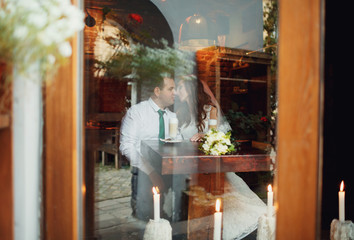 The charming couple in love sitting in the restaurant