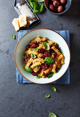 Fussili pasta with olives, capers, dried tomatoes and parmesan