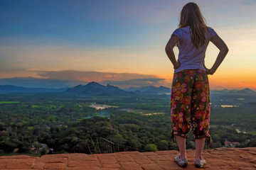 Female hiker standing on edge of Sigiriya rock