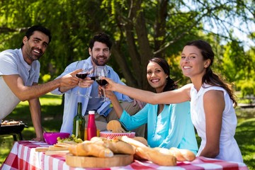 Portrait of happy couple toasting a glasses of wine