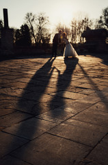 young man walks with his bride evening