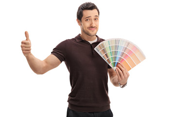 Man holding color swatch and making thumb up sign