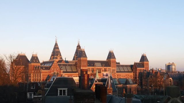 Rooftop of monumental building in afternoon golden sunlight filmed from a roof, Amsterdam. 