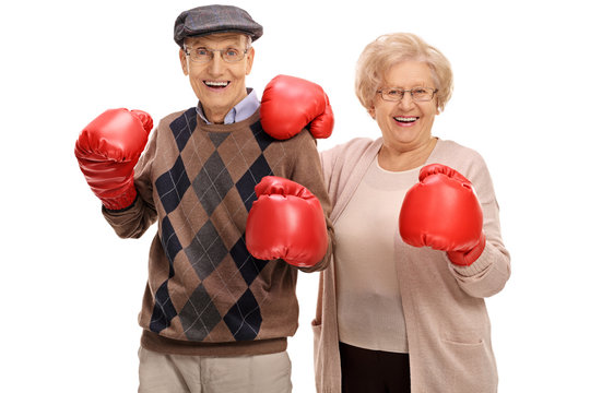 Joyful seniors posing with boxing gloves