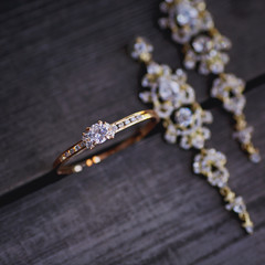 close up of the wedding jewelry on wooden background 