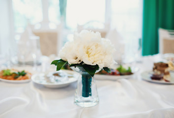 Bouquet of the bride at the wedding table