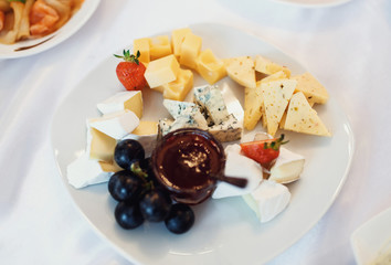 A variety of cheeses with jam