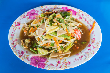green papaya spicy salad Thai style on blue background