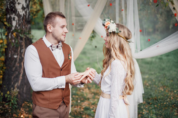 The groom wears a ring bride. Wedding ceremony.