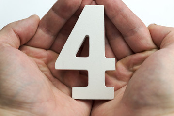Hands holding number four.