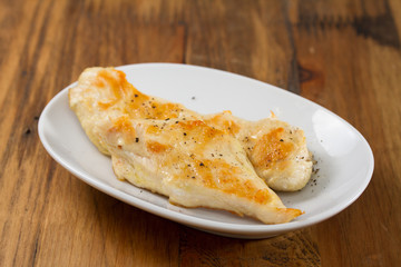 grilled chicken breast on white dish