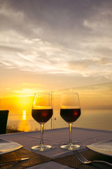 two glasses of wine on the background of the setting sun. Valentine's Day. romantic dinner for two.