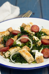 salad with grilled chicken and smoked sausage on plate