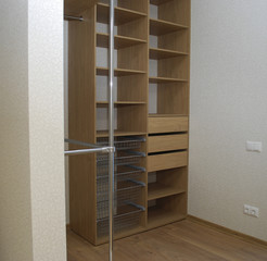 Wooden walk-in wardrobe, shelves and baskets.