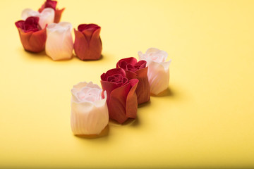 Fototapeta na wymiar Valentines day roses on yellow background