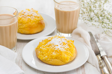 traditional portuguese bread pao de deus and coffee with milk