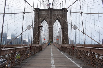 A Tower of Brooklyn Bridge in New York City in a Foggy Day