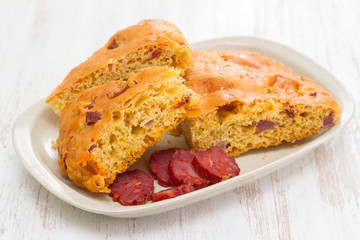 bread with  chourico on white dish