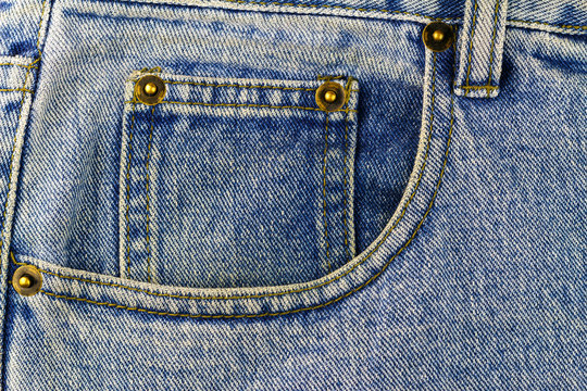 Front pocket of blue jeans, denim texture background