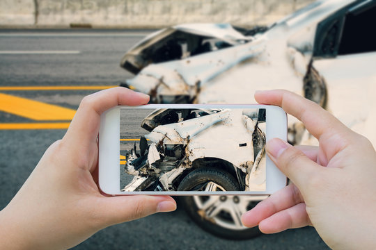 woman using smartphone take photo of car crash accident on the r