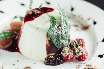 Cake Panna cotta on white plate on wooden table