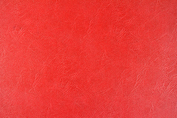 Red leather texture background, close up view.