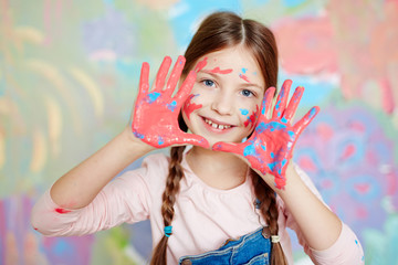 Girl with colorful palms looking at camera