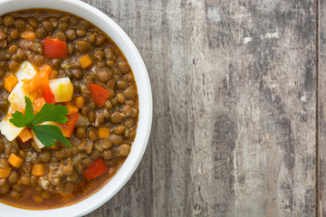 Lentil soup in a bowl on wooden background
