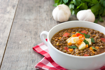 Lentil soup in a bowl on wooden background
