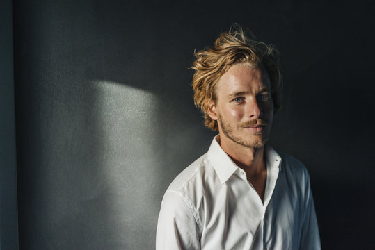 Portrait Of Smiling Blond Man Wearing White Shirt