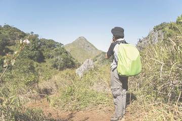 backpacker traveler with backpack in mountaineering Travel Lifestyle concept.