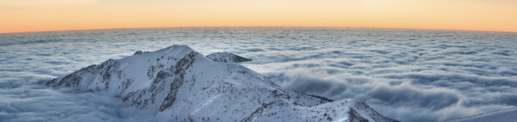 Mountain range above the clouds in the evening Twilight view
