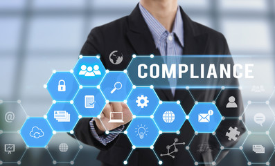 Businessman hand pressing button Compliance. sign on virtual screen. business quality law concept.