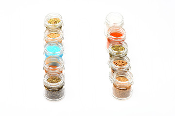 various spices in jars on white background