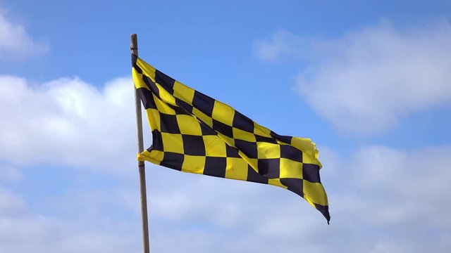 High quality video of yellow and black checkered Flag in 4K
