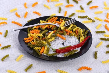 plate with pasta, fork, salt, chili pepper