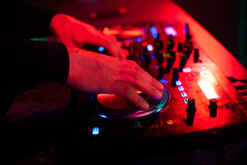 hands DJ music mixer on the party in the night club