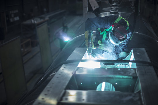 Man welding steel in factory