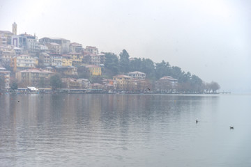 Foggy winter scenery at the lake of Kastoria Greece, during a he - 136318682
