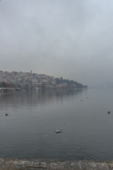 Foggy winter scenery at the lake of Kastoria Greece, during a he - 136318881