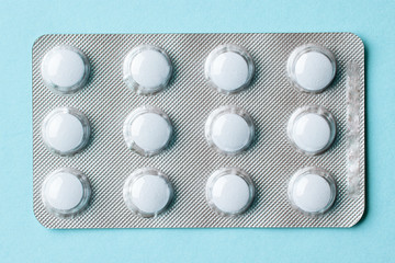 white pills on blue background