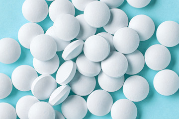 white pills on blue background
