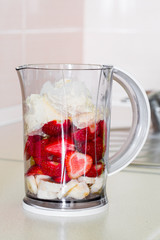 fresh fruit in a blender bowl.