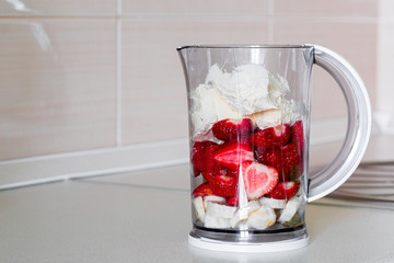 fresh fruit in a blender bowl.