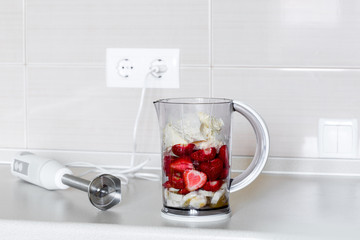 fresh fruit in a blender bowl.